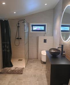 a bathroom with a shower and a toilet and a sink at Small farm in Bjørheimsbygd, 30 min from Preikestolen in Strand +36 photos