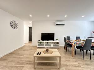 a living room with a table and a tv at Portimao Central Town 2 by Homing in Portimão