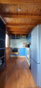 a kitchen with blue cabinets and a white refrigerator at Finse woning nabij groot meer in Rohel