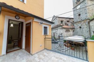 a balcony of a building with a door and a building at B&B Magliuolo in San Giovanni a Piro