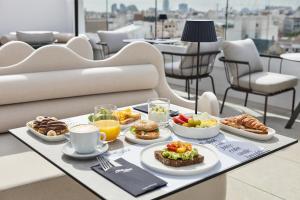 a tray of food on a table with breakfast foods at One Shot Puerta Ruzafa in Valencia
