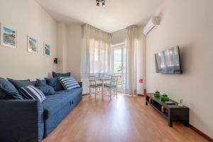 a living room with a blue couch and a table at Elegant Apartments Rapallo in Rapallo