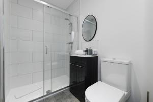 Un baño blanco con inodoro y espejo. en Convenient 1 - Bed in Central Matlock Near Station, en Matlock