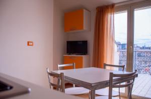 a dining room with a table and chairs and a window at Residence Playa Sirena in Tortoreto Lido