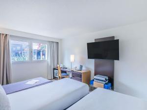 Кровать или кровати в номере Novotel Setubal