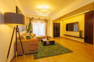 a living room with a couch and a table at Villa Blanche in Douala