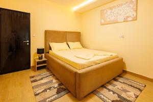a small bedroom with a bed and a black door at Villa Blanche in Douala