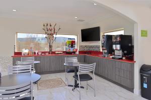 una cocina con mesas, sillas y una barra en Americas Best Value Inn & Suites - Houston/Hwy 6 & Westpark, en Houston