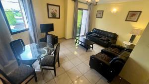 a living room with a couch and a glass table at Résidence saint James in Douala +36 photos