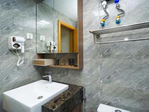 a bathroom with a sink and a mirror at X One Hotel in Phnom Penh