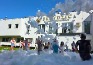 a group of people playing in the snow at Prawdzic Family Resort & Wellness in Gdańsk