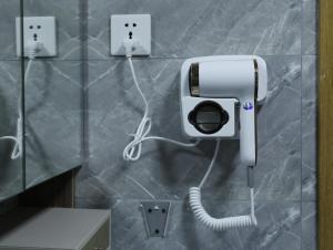 a phone on a wall with a cord plugged into it at X One Hotel in Phnom Penh