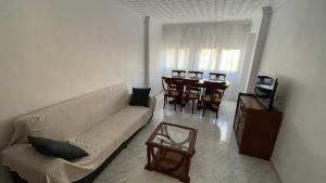 a living room with a white couch and a table at Respiro in Vinarós