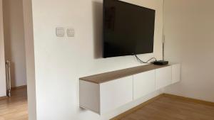 a flat screen tv on a white wall at BT Lux apartment 2 in Skopje