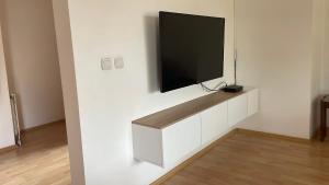 a flat screen tv hanging on a wall at BT Lux apartment 2 in Skopje