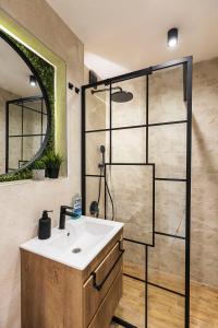a bathroom with a sink and a shower at D-home in Sofia