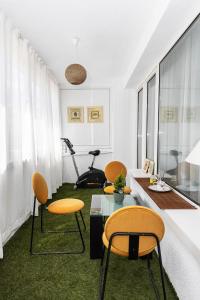 a living room with chairs and a table and a treadmill at D-home in Sofia +29 photos