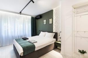 a small bedroom with a bed and a shower at D-home in Sofia