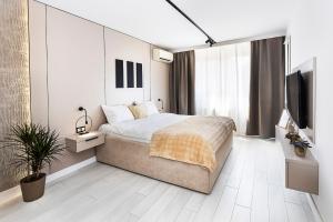 a bedroom with a bed and a flat screen tv at D-home in Sofia