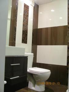 a bathroom with a toilet and a sink and a mirror at Dimitur Jekov Guest House in Obzor +17 photos