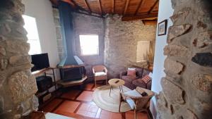 a living room with a couch and a table at Quintinha dos Amores in Vila Verde