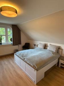 a bedroom with a large bed in a room at Waldhotel Süllhof in Steyerberg
