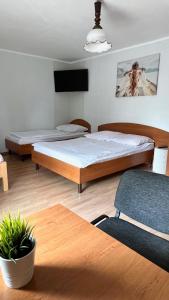 Posteľ alebo postele v izbe v ubytovaní POD BOROWIKIEM