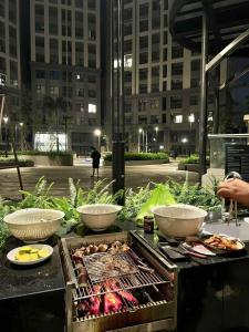 a grill with three bowls of food on a table at Green Zone - San Tower Dragon Castle in Ha Long