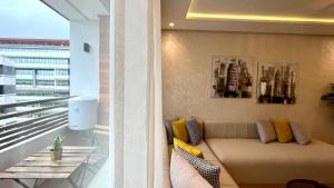 a living room with a couch on a balcony at The Suite of Artists - Central - By AppartAli in Casablanca