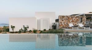 a swimming pool in front of a white house at TWWO Antiparos in Antiparos