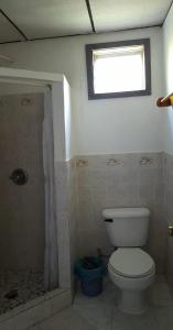 a bathroom with a toilet and a window at La Casa de Don David in El Remate +43 photos