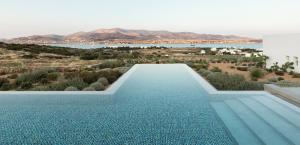 a swimming pool with a view of the water at TWWO Antiparos in Antiparos