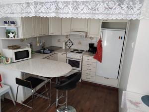 a kitchen with a white refrigerator and a table at Cozy big apartment near center in Oulu +9 photos