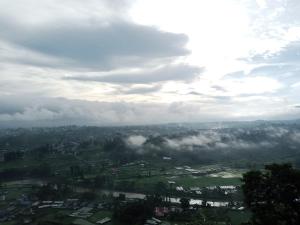 an aerial view of a city with clouds in the sky at Hotel Sabaiko in Kathmandu
