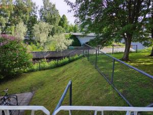 a view of a yard with a fence at Cozy big apartment near center in Oulu