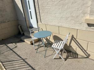 a table and two chairs sitting next to a door at Villa Juliette in Le Tréport +4 photos