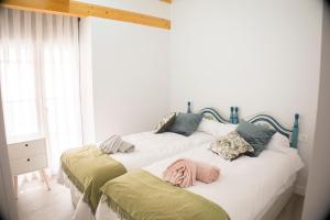 Ένα ή περισσότερα κρεβάτια σε δωμάτιο στο VIA DE LA PLATA SUITES 1a