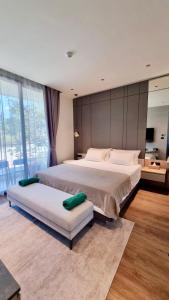 a large bedroom with two beds and a large window at Cosy 2 bedroom family apartment Layan beach in Layan Beach