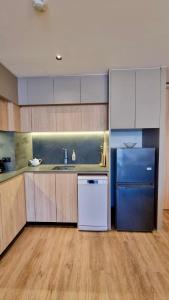 a kitchen with a refrigerator and a sink at Cosy 2 bedroom family apartment Layan beach in Layan Beach