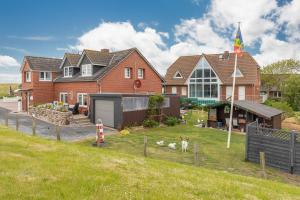a house with a flag in the yard at Haus Seeblick _ Wohnung 1 in Dagebüll