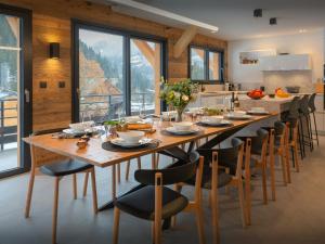 a large dining room with a long table and chairs at Chalet Alphonse - OVO Network in Châtel +24 photos