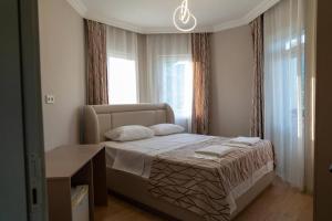 a bedroom with a bed with two pillows on it at Green Garden Otel in Kemer
