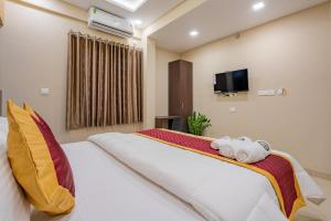 a bedroom with a bed with two towels on it at Boat Residency in Cochin