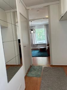 a hallway of a living room with a mirror at Costal Stay with Forest Views in Helsinki +7 photos