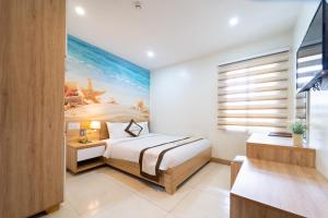 Postel nebo postele na pokoji v ubytování Bella Hotel Bai Sau Vung Tau