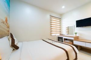 Postel nebo postele na pokoji v ubytování Bella Hotel Bai Sau Vung Tau