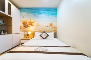 Postel nebo postele na pokoji v ubytování Bella Hotel Bai Sau Vung Tau