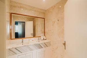 a bathroom with a sink and a mirror at Velamar Boutique Hotel - Adults Friendly in Albufeira
