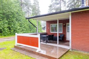 a screened in porch of a house with a table at Lomakatti Apartments in Vuokatti