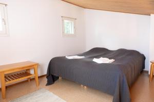 a bedroom with a bed and a table and a window at Lomakatti Apartments in Vuokatti